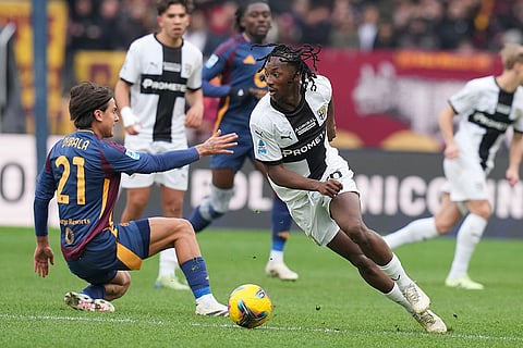 Serie A 2024-25: Parma's Woyo Coulibaly, right, takes on Roma's Paulo Dybala