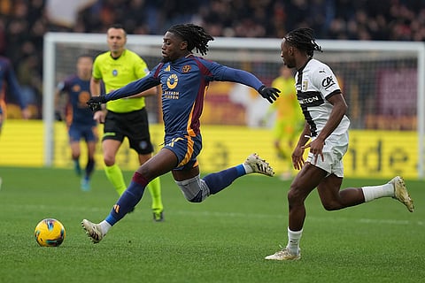 Serie A 2024-25: Roma's Manu Kone, left, is about to kick the ball