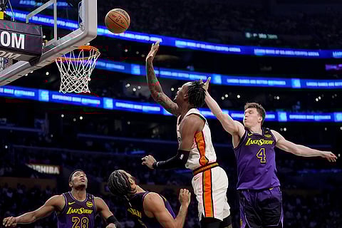 NBA 2024-25: Pistons forward Ronald Holland II, center, shoots over Los Angeles Lakers forward Rui Hachimura