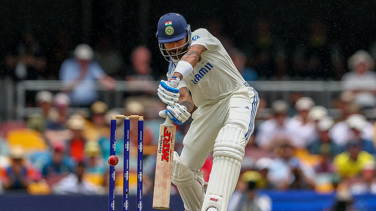 AP Photo/Pat Hoelscher : India's Virat Kohli bats during play on day three of the third cricket test between India and Australia at the Gabba in Brisbane, Australia.