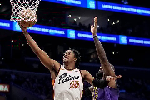 NBA 2024-25: Pistons guard Jaden Ivey, left, drives to the basket around Los Angeles Lakers forward LeBron James