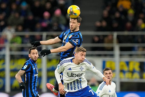 Serie A 2024-25: Inter Milan's Carlos Augusto, top, and Como's Ignace Van Der Brempt jump for the ball