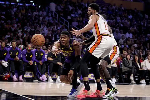 NBA 2024-25: Lakers forward Rui Hachimura fights for a loose ball against Pistons forward Tobias Harris