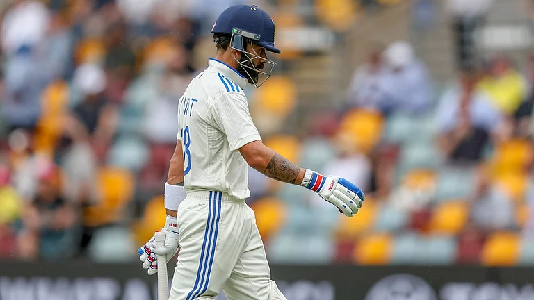 Virat Kohli walks back after being dismissed in the third India vs Australia Test in Brisbane. - AP