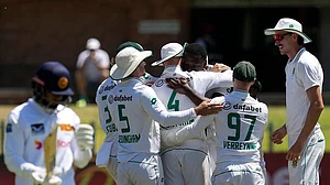 | Photo: AP/Themba Hadebe : RSA Vs SL, 2nd Test: South Africa's Kagiso Rabada celebrates with his teammates after dismissing Sri Lanka's captain Dhananjaya de Silva