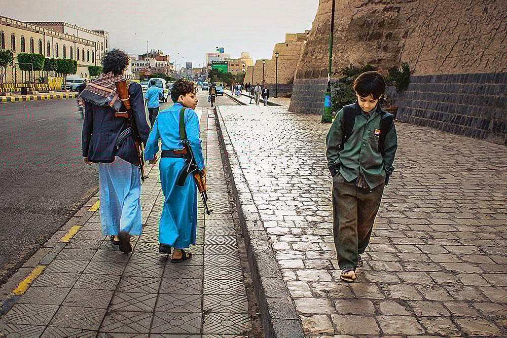 | Photos: Ali Al-Senaidar : Contrasting Journeys: One boy goes to school, the other suffers the war 
