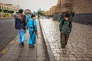 | Photos: Ali Al-Senaidar : Contrasting Journeys: One boy goes to school, the other suffers the war