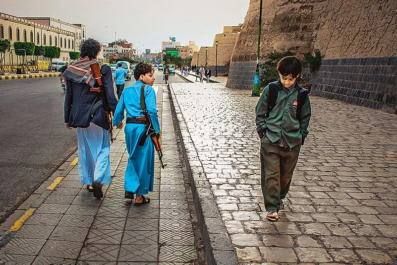 Contrasting Journeys: One boy goes to school, the other suffers the war