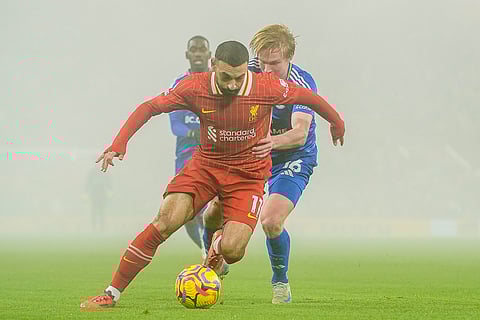 EPL 2024-25: Liverpool's Mohamed Salah controls a ball chased by Leicester's Victor Kristiansen