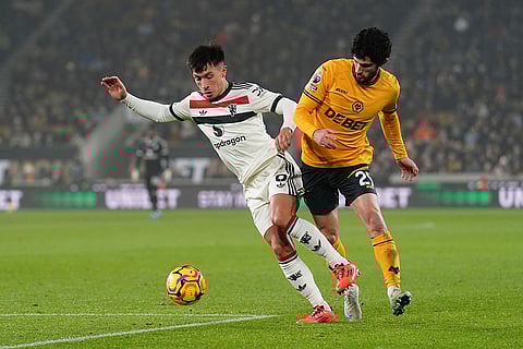 EPL 2024-25: Manchester United's Lisandro Martinez, left, and Wolves Goncalo Guedes challenge for the ball