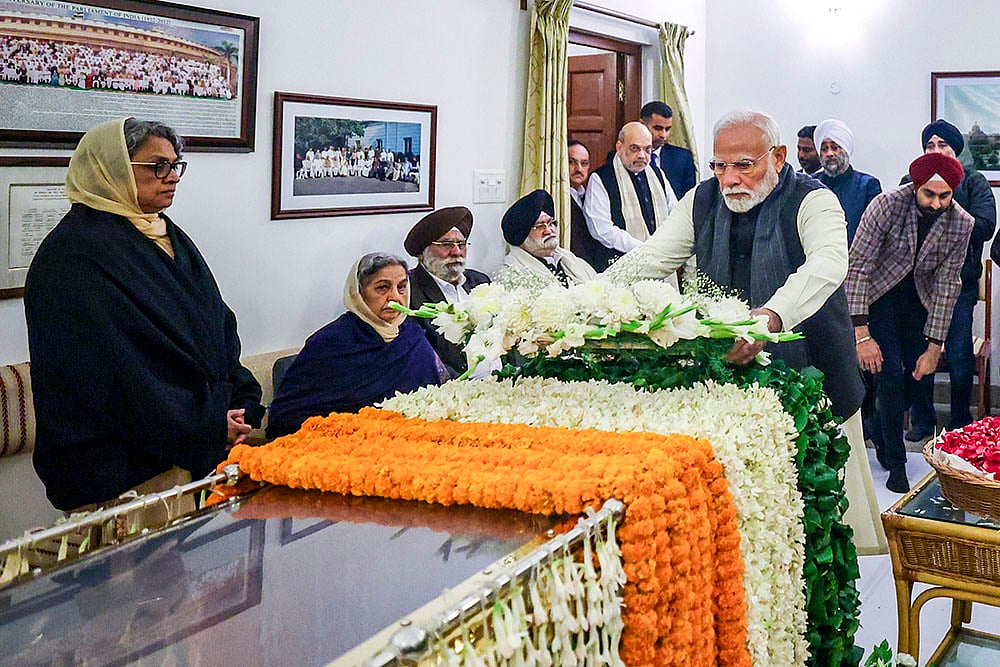| Photo: PTI : PM Modi pays tribute to Manmohan Singh