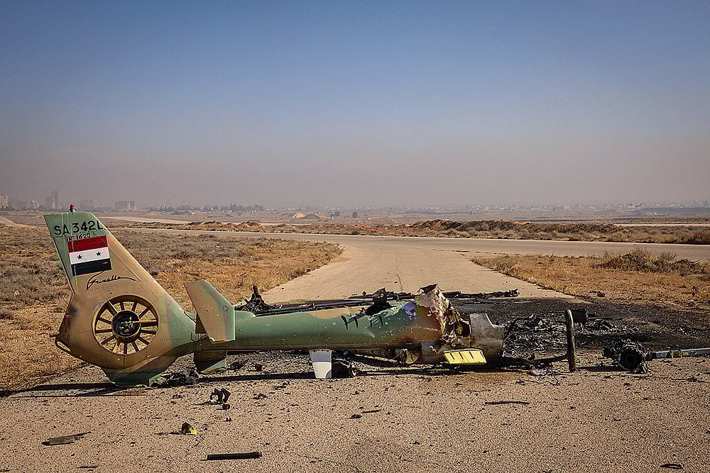 Photo: Getty Images : Shot Down: A Syrian Air Force helicopter is destroyed after Israeli 
strikes against military targets across Syria in December