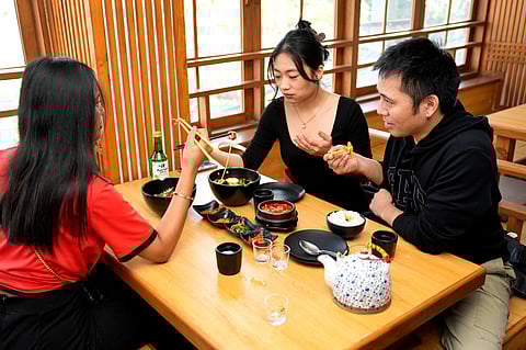 A group of friends enjoys authentic Korean cuisine at Gangnam Korean Restaurant in Majnu-ka-Tilla.