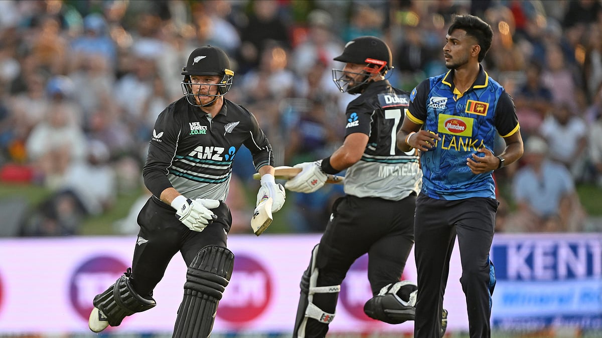 Andrew Cornaga/Photosport via AP : New Zealand's Glenn Phillips runs as Sri Lanka's Matheesha Pathirana looks on during the first Twenty20 international cricket match between New Zealand and Sri Lanka at Mt Maunganui, New Zealand.