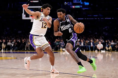 NBA: Kings guard Malik Monk drives past Lakers guard Max Christie