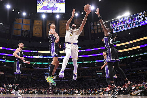 NBA: Lakers forward Anthony Davis (3) shoots as Kings forward Trey Lyles (41) and guard Keon Ellis (23) defend