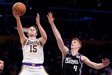 NBA: Lakers guard Austin Reaves shoots as Kings guard Kevin Huerter defends