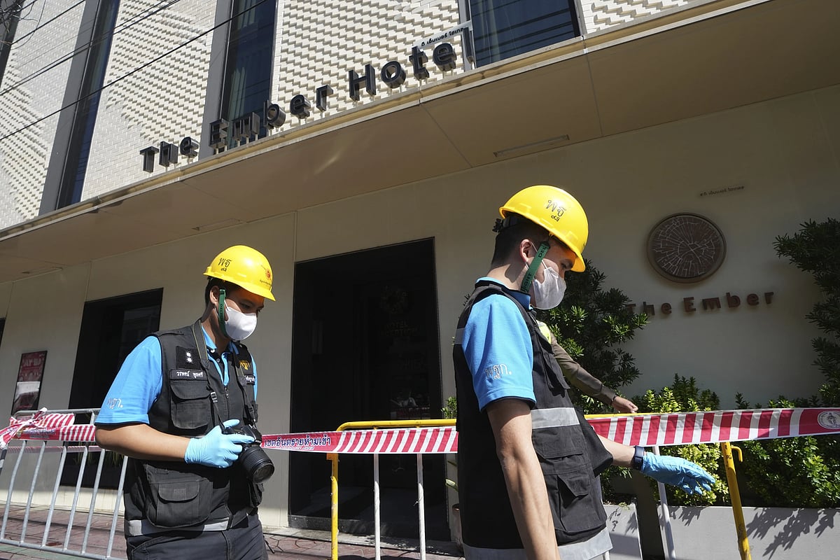 AP : Police forensic team arrive at the hotel after fire incident.