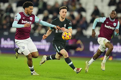 EPL 2024-25: Liverpool's Diogo Jota, center, and West Ham's Jean-Clair Todibo vie for the ball
