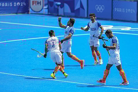 Harmanpreet Singh celebrates with teammates after scoring a goal
