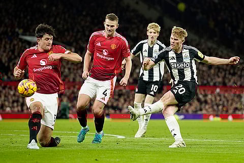 EPL 2024-25: Manchester United's Harry Maguire, left, tries to block a shot from Newcastle's Lewis Hall