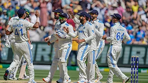 AP Photo/Asanka Brendon Ratnayake : Indian players celebrate the wicket of Australia's Mitchell Starc during play on day four of the fourth cricket test between Australia and India at the Melbourne Cricket Ground.