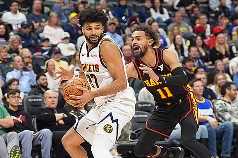 NBA 2024-25: Nuggets guard Jamal Murray, left, looks to pass the ball