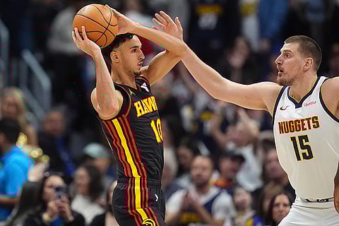 NBA 2024-25: Hawks forward Zaccharie Risacher, left, looks to pass the ball