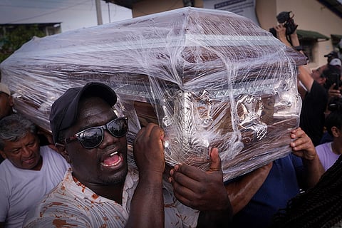 Ecuador Missing Children: Family and friends carry the caskets of four children