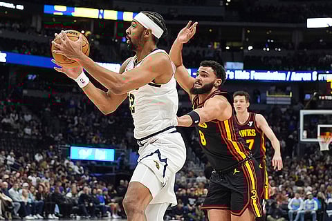 NBA 2024-25: Nuggets forward Zeke Nnaji, left, pulls in a rebound as Hawks forward David Roddy defends