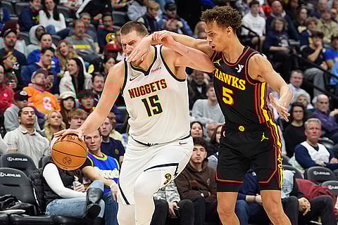 NBA 2024-25: Nuggets center Nikola Jokic, left, gets hit in the face as he drives to the basket