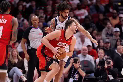NBA 2024-25: Rockets' Alperen Sengun, bottom, is fouled by Mavericks' Dereck Lively II