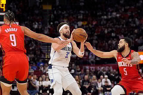 NBA 2024-25: Mavericks' Klay Thompson shoots as Rockets' Fred VanVleet (5) and Dillon Brooks (9) defend