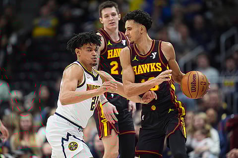 NBA 2024-25: Hawks forward Zaccharie Risacher, right, looks to pass the ball