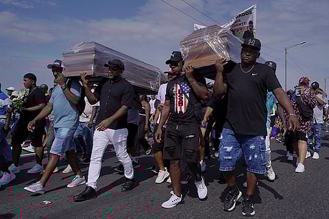 Ecuador Missing Children: Family and friends carry the caskets to cemetery