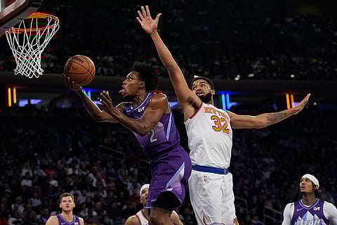 NBA 2024-25: Jazz's Collin Sexton (2) drives past Knicks' Karl-Anthony Towns