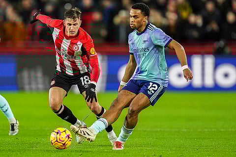 EPL 2024-25: Arsenal's Jurrien Timber kicks the ball next to Brentford's Yehor Yarmoliuk