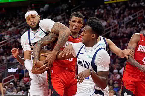NBA 2024-25: Rockets' Jabari Smith Jr., center, battles Mavericks' players