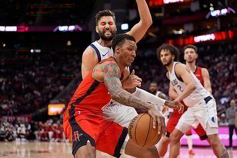 NBA 2024-25: Rockets' Jabari Smith Jr., front, drives toward the basket as Dallas Mavericks' Maxi Kleber defends