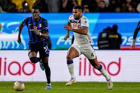 Italian Super Cup 2024-25: Inter Milan's Yann Bisseck, left, runs with the ball next to Atalanta's Isak Hie
