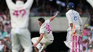 Photo: AP : Pat Cummins falls as he appeals unsuccessfully for a wicket during the second day of the fifth Test between India and Australia at the Sydney Cricket Ground.