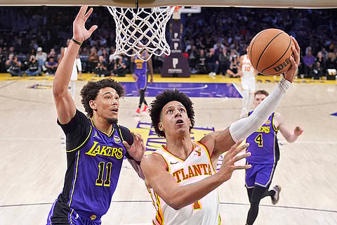 NBA 2024-25: Hawks forward Jalen Johnson, right, shoots as Los Angeles Lakers center Jaxson Hayes defends