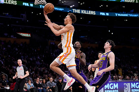NBA 2024-25: Hawks guard Dyson Daniels, left, shoots as Lakers forward Dorian Finney-Smith defend