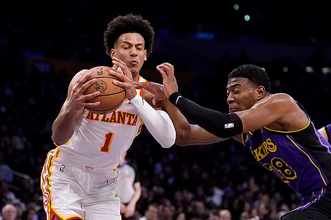 NBA 2024-25: Hawks forward Jalen Johnson, left, tries to shoot as Lakers forward Rui Hachimura