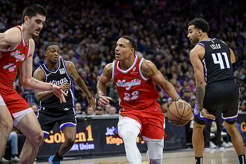 NBA 2024-25: Grizzlies guard Desmond Bane (22) drives past Kings guard De'Aaron Fox and Trey Lyles