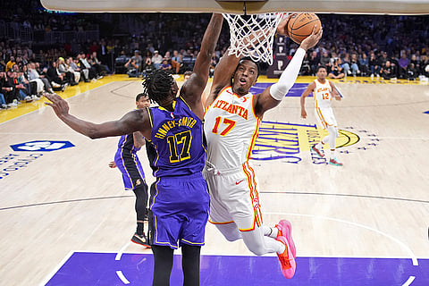 NBA 2024-25: Hawks forward Onyeka Okongwu, right, shoots as Lakers forward Dorian Finney-Smith defends