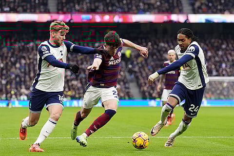 EPL 2024-25: Newcastle United's Tino Livramento battles for the ball with Tottenham players