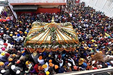 Devotees take part in the 'Nagar Kirtan' procession as part of the celebration of the 10th Sikh Guru, Guru Gobind Singh Ji's