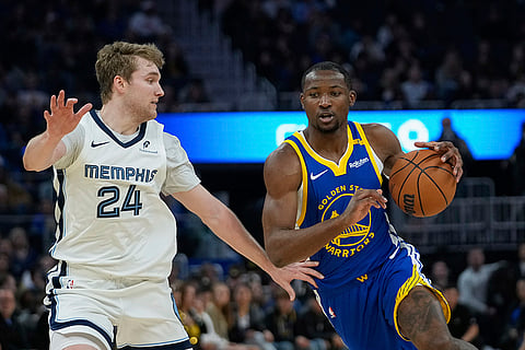 NBA 2024-25: Warriors forward Jonathan Kuminga moves the ball while defended by Grizzlies guard