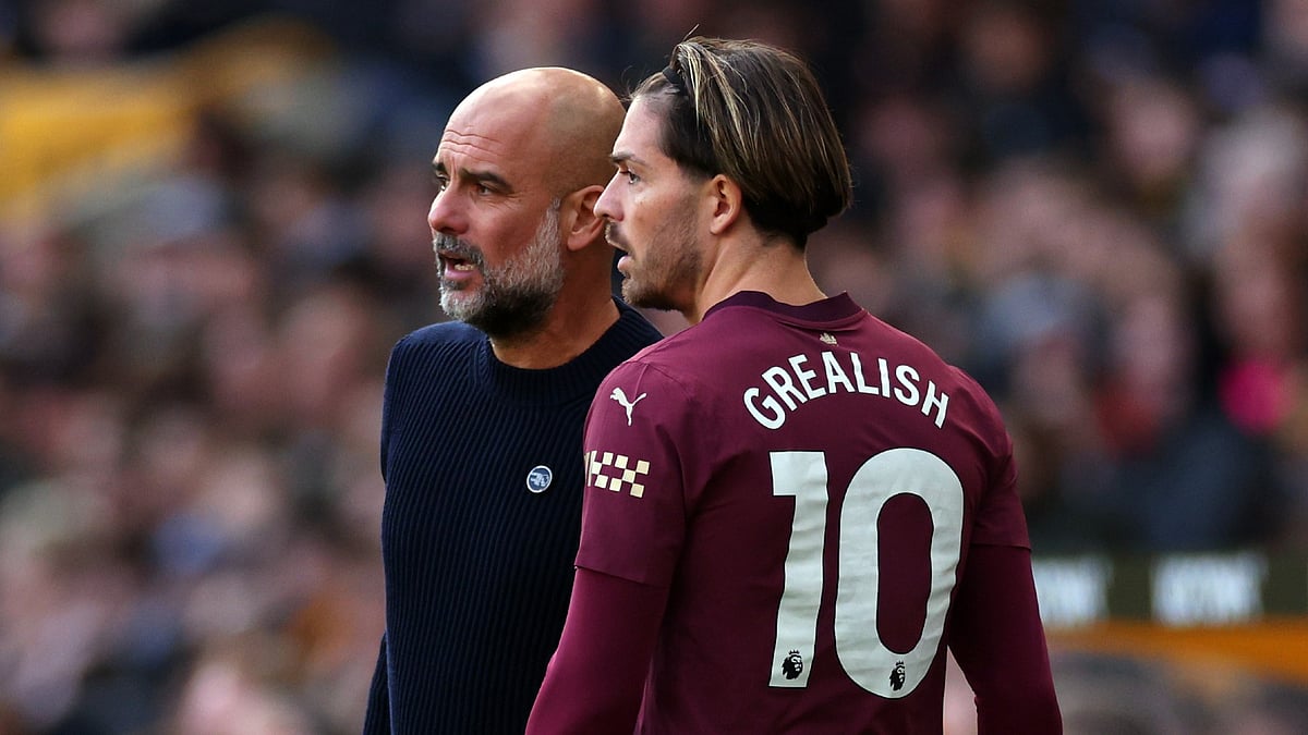 Manchester City manager Pep Guardiola with Jack Grealish